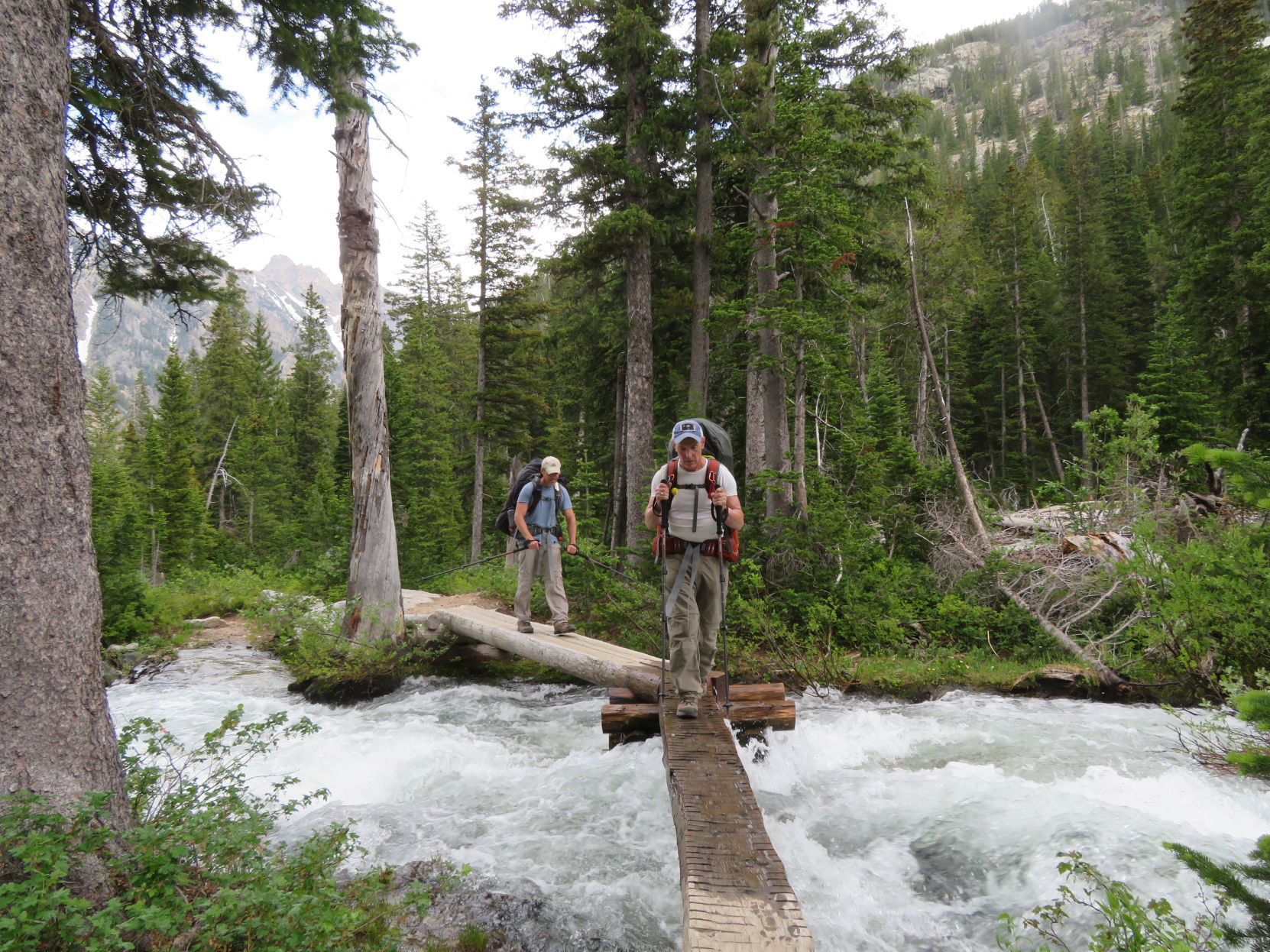 Crossing stream on board in Tetons
